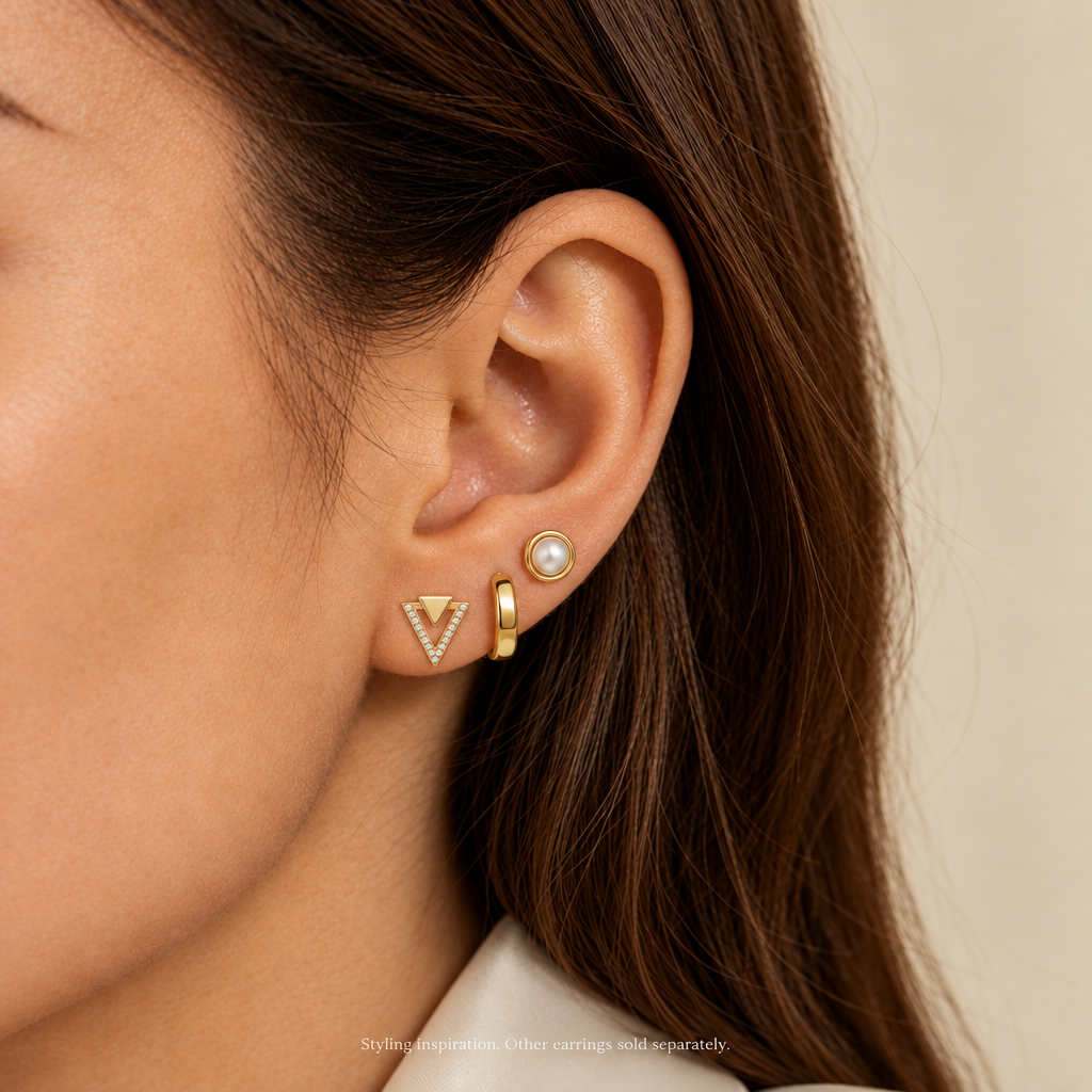 AI-generated V-Geometry Pavé Studs ear stack with solid gold upper triangle; other earrings sold separately